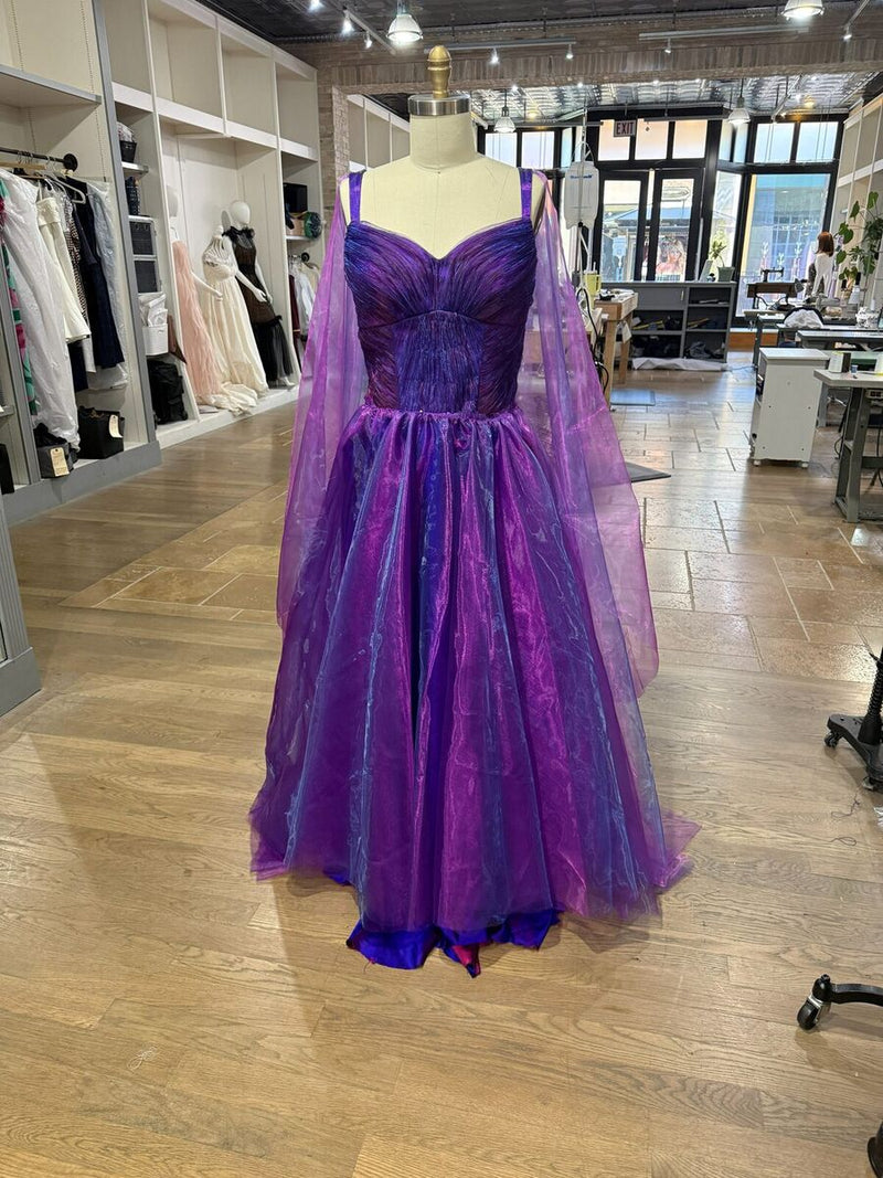 A purple tulle ballgown with a sweetheart bodice and floor length cape sleeves, in the Style Adix fitting room