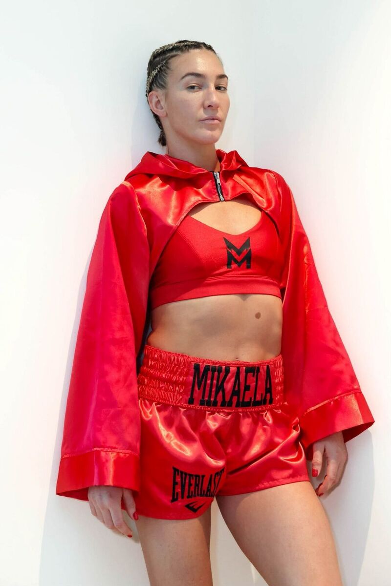 Custom red satin ring wear with a hooded cape, built by Style Adix for world champion boxer Mikaela Mayer