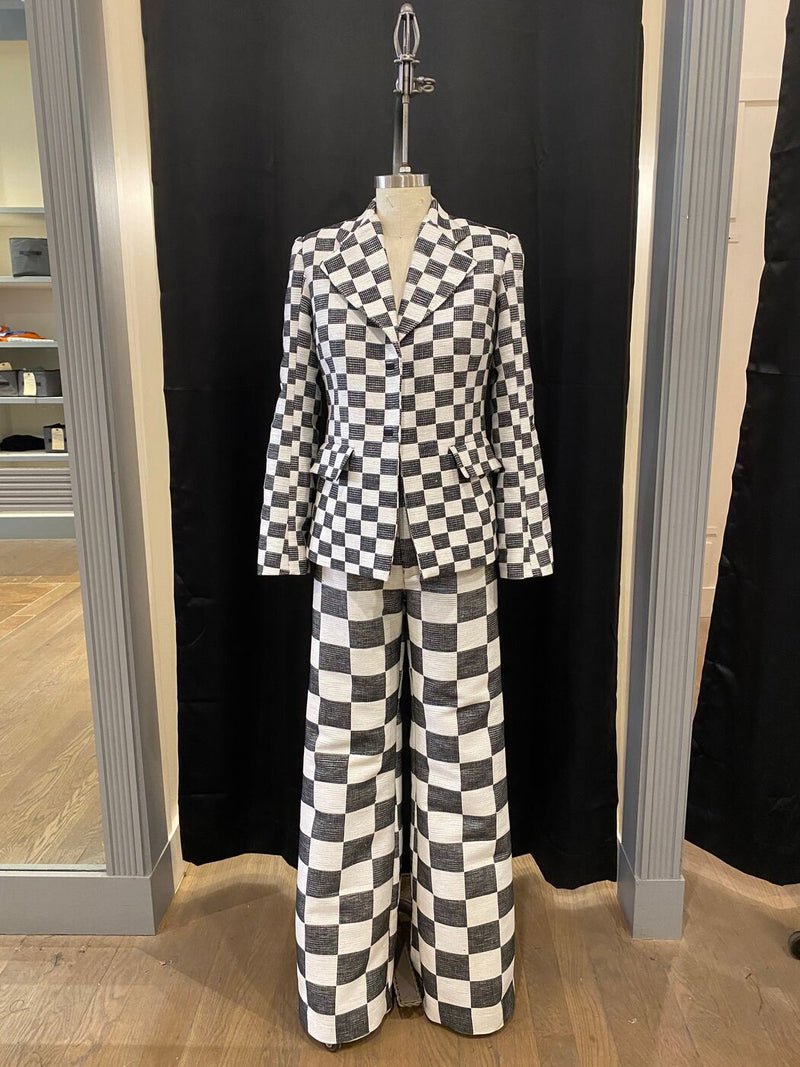 A black and white checkerboard jacket and flared trousers built as period wardrobe for a film production