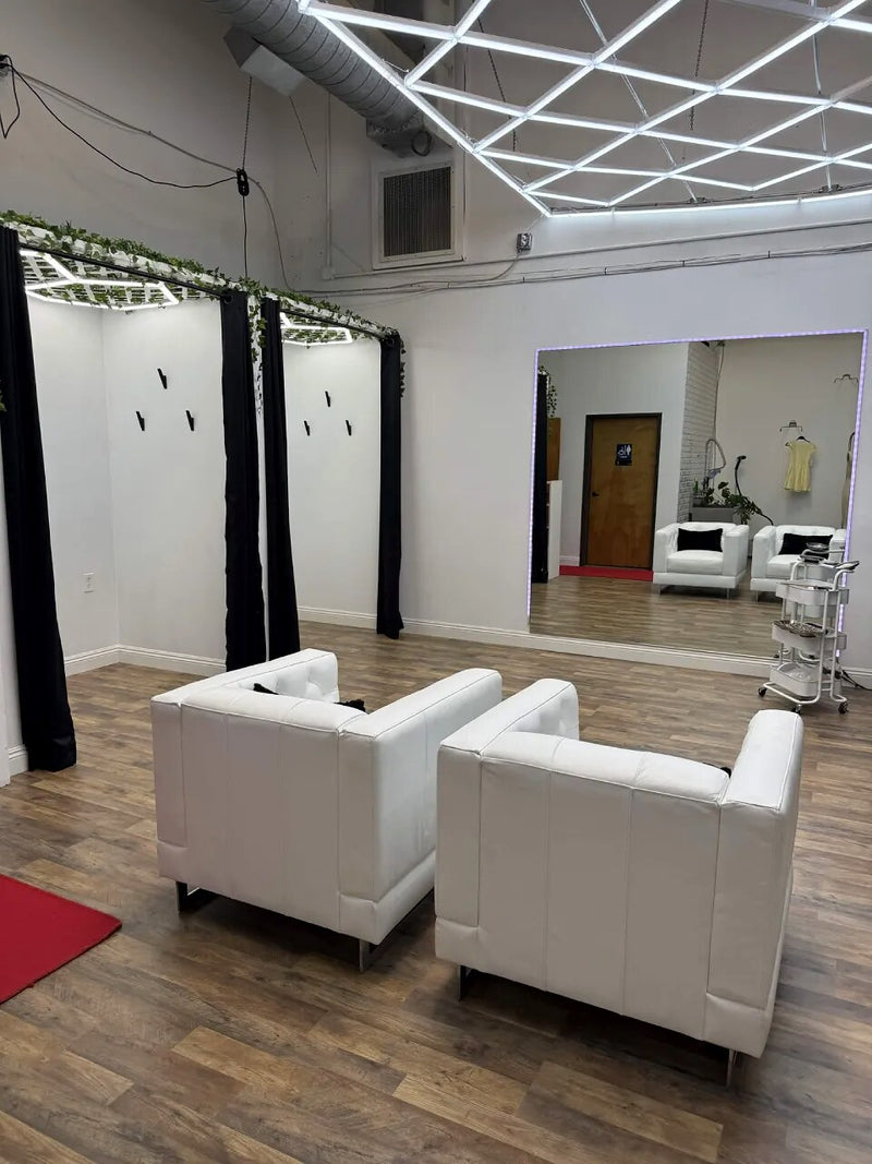 A fitting area with armchairs and a full length mirror
